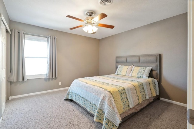 carpeted bedroom with a ceiling fan, a closet, visible vents, and baseboards