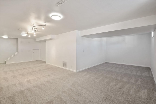 finished below grade area featuring carpet floors, visible vents, and baseboards