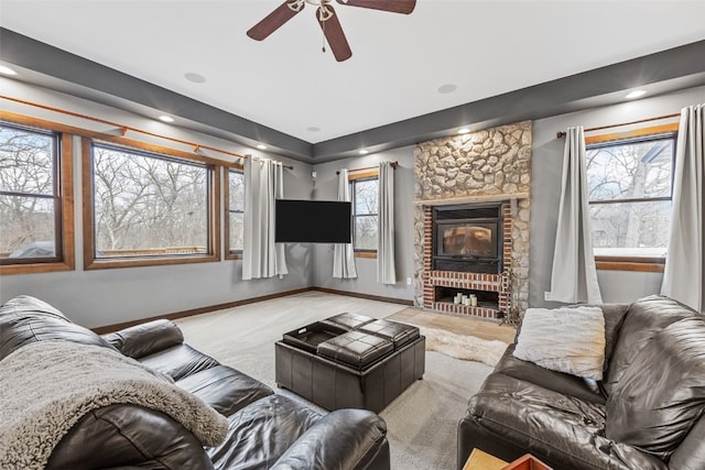 carpeted living room with a fireplace and baseboards