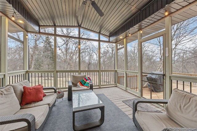 sunroom featuring vaulted ceiling and ceiling fan