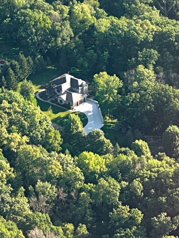 birds eye view of property with a wooded view