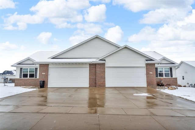 ranch-style house featuring concrete driveway, brick siding, and a garage