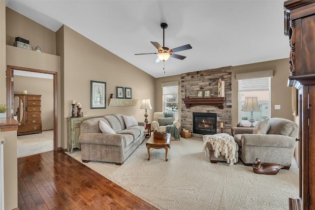 living room with a fireplace, high vaulted ceiling, a ceiling fan, and wood-type flooring