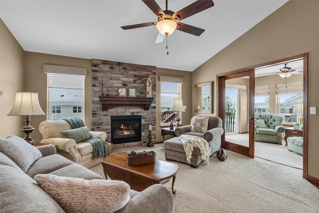 living room with a fireplace, vaulted ceiling, light colored carpet, and a ceiling fan