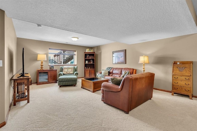 carpeted living area with baseboards and a textured ceiling