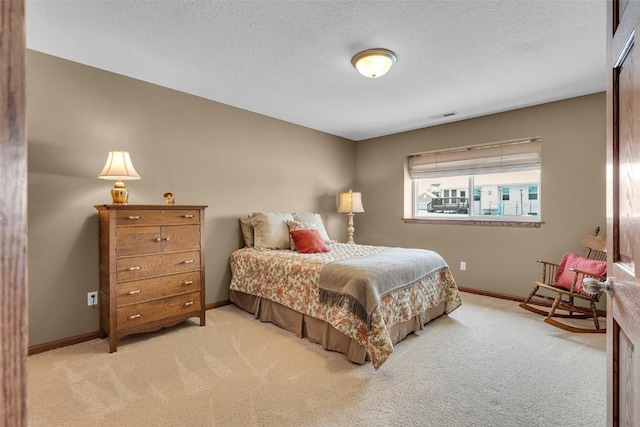 bedroom with visible vents, baseboards, and light colored carpet