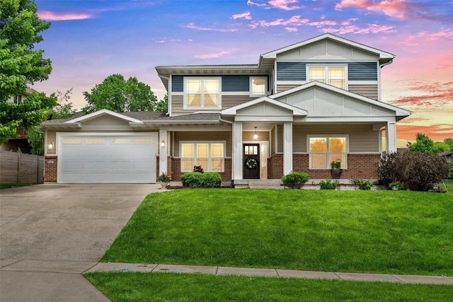 view of front of home with a garage, driveway, a lawn, a porch, and brick siding