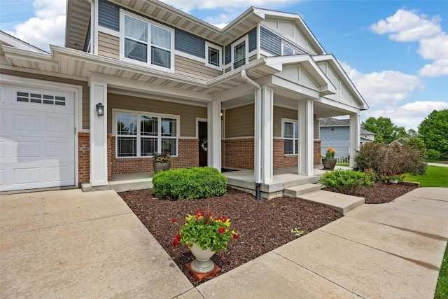 view of front of home with covered porch, brick siding, and an attached garage