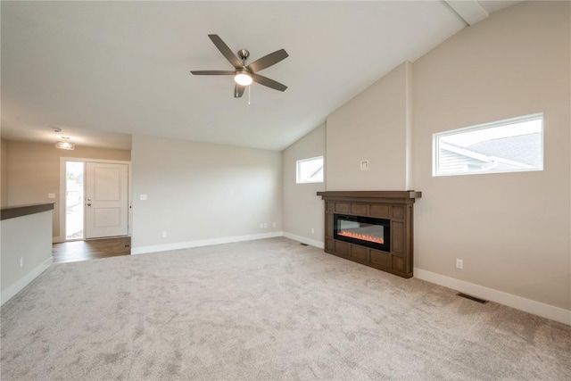 6166 Cope Dr, Marion, IA 52302 - unfurnished living room with carpet, a ceiling fan, a glass covered fireplace, lofted ceiling, and baseboards