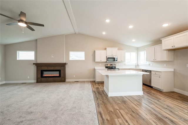 6166 Cope Dr, Marion, IA 52302 - kitchen with appliances with stainless steel finishes, a kitchen island, a sink, white cabinets, and recessed lighting