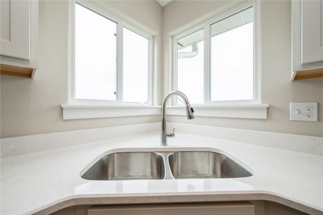 6166 Cope Dr, Marion, IA 52302 - kitchen featuring light countertops, a sink, and white cabinetry