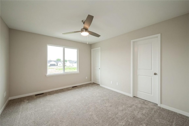 6166 Cope Dr, Marion, IA 52302 - unfurnished bedroom with carpet floors, baseboards, and a ceiling fan