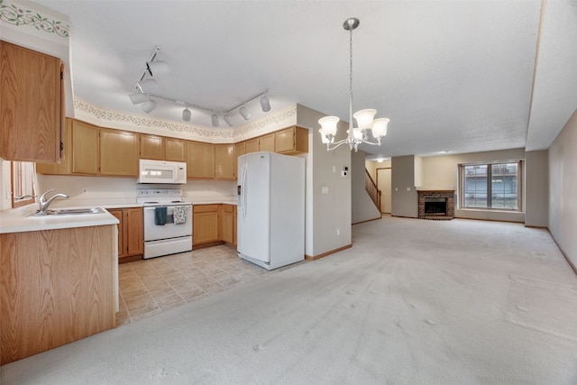 kitchen with open floor plan, light colored carpet, light countertops, white appliances, and a sink