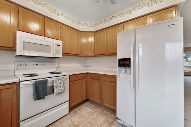 kitchen featuring white appliances, a textured ceiling, brown cabinets, and light countertops