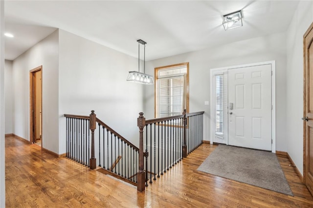 foyer entrance with wood finished floors and baseboards