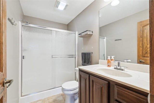 bathroom with visible vents, a shower stall, toilet, and vanity