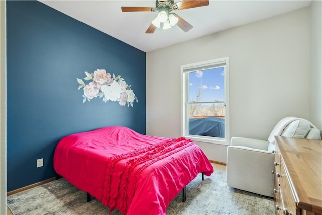 bedroom with a ceiling fan and baseboards