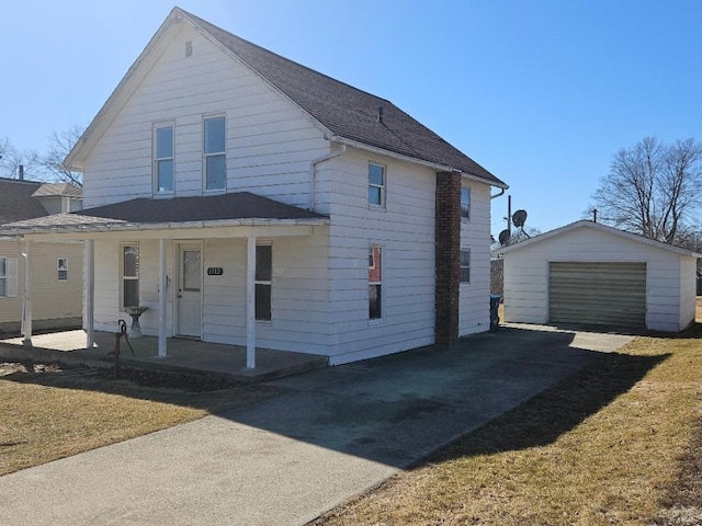 view of front of house featuring a detached garage, a porch, roof with shingles, an outdoor structure, and driveway