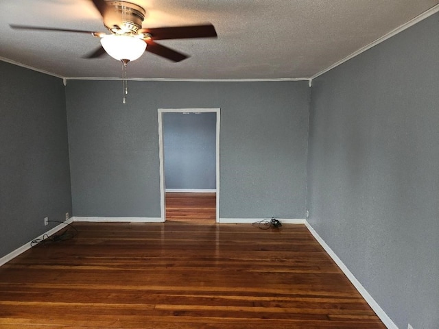 empty room featuring crown molding, wood finished floors, baseboards, and a textured ceiling