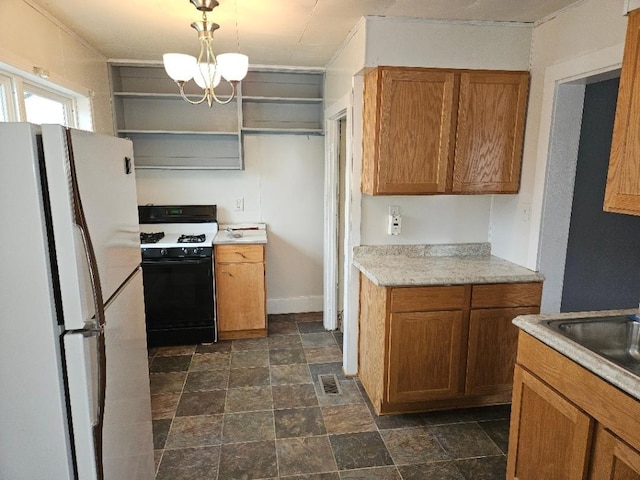 kitchen featuring stone finish floor, open shelves, gas range oven, freestanding refrigerator, and brown cabinetry