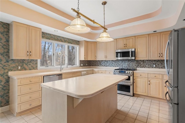 kitchen with light brown cabinetry, wallpapered walls, stainless steel appliances, and a raised ceiling