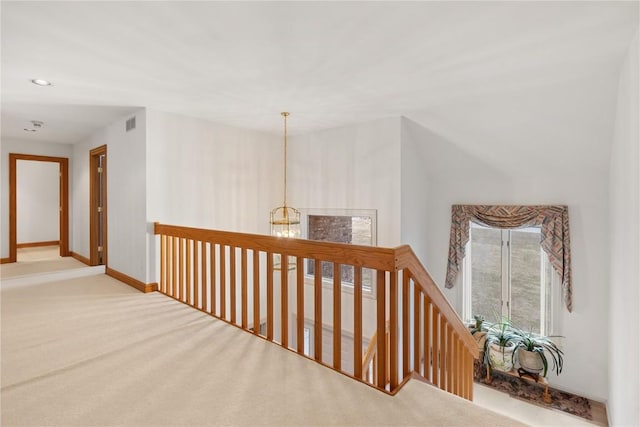 corridor featuring visible vents, recessed lighting, carpet, an inviting chandelier, and baseboards