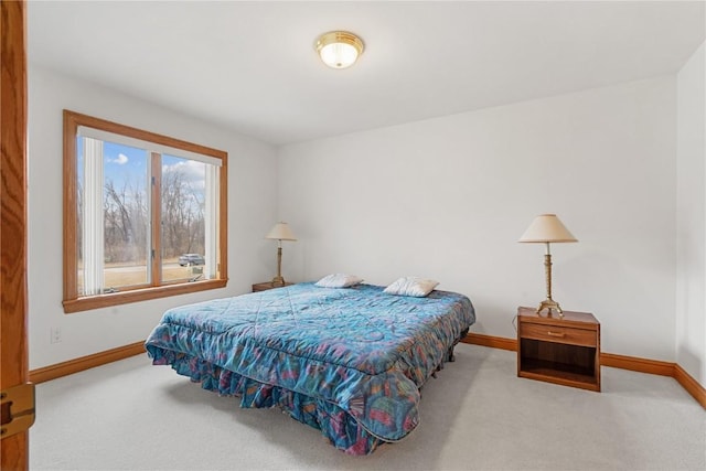 bedroom with baseboards and carpet floors