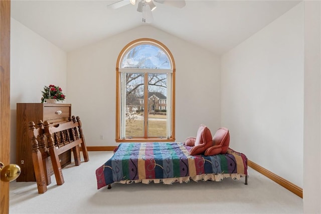 carpeted bedroom featuring vaulted ceiling, a ceiling fan, and baseboards