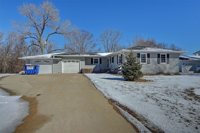 ranch-style house featuring driveway and an attached garage