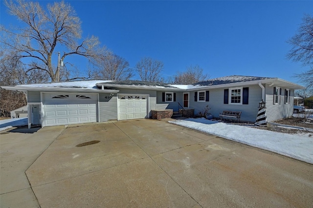 single story home with entry steps, a garage, and driveway