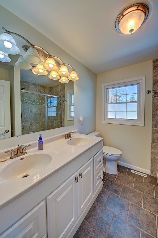 full bath featuring visible vents, plenty of natural light, and a sink