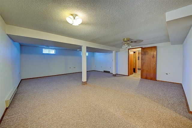 basement with a baseboard radiator, baseboards, and a textured ceiling