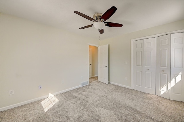 unfurnished bedroom with a closet, visible vents, baseboards, and carpet floors