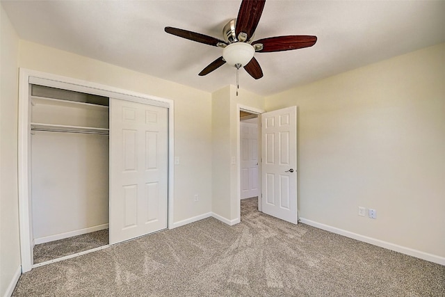 unfurnished bedroom with baseboards, carpet floors, a closet, and ceiling fan