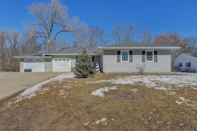 single story home featuring concrete driveway and an attached garage