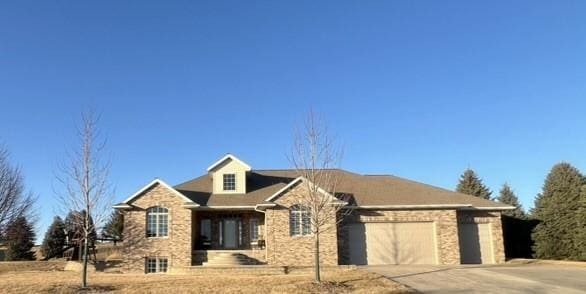 view of front facade featuring driveway and an attached garage