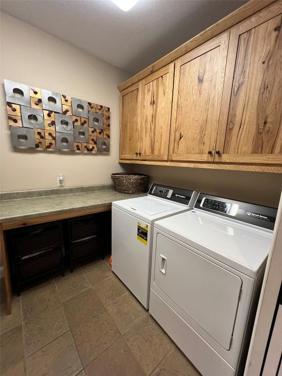 clothes washing area featuring washer and clothes dryer, cabinet space, and mail area