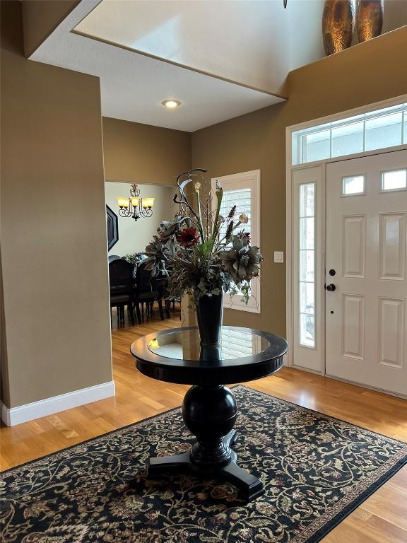 entryway with a chandelier and light wood-style floors