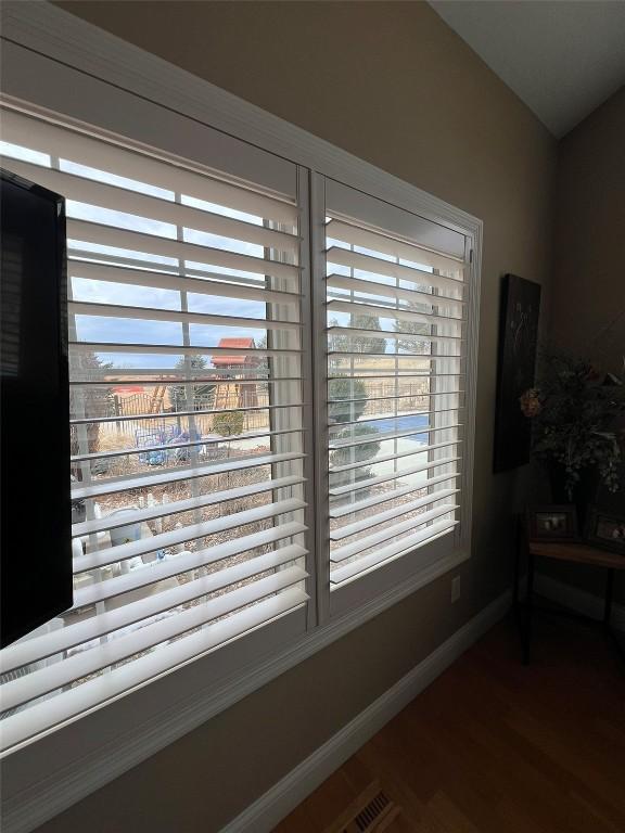 room details featuring baseboards and wood finished floors