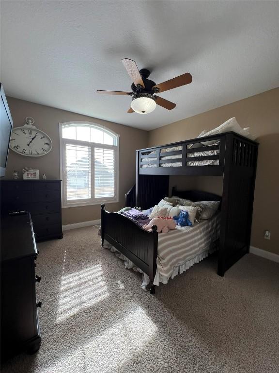 bedroom with baseboards, carpet, and a ceiling fan