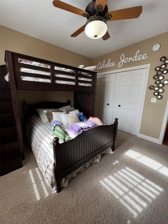 bedroom with baseboards, a closet, carpet floors, and ceiling fan