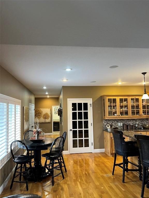 dining area with light wood finished floors, recessed lighting, and baseboards