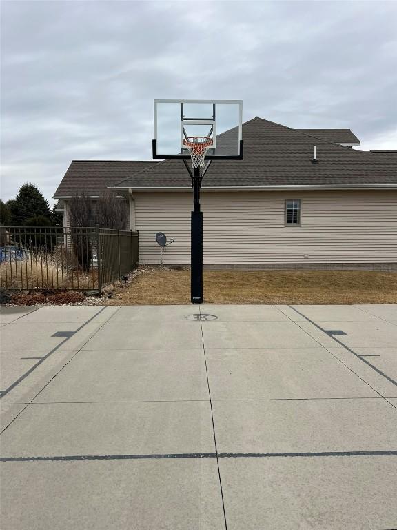 view of basketball court featuring fence