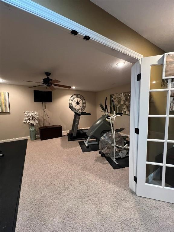 exercise room featuring a ceiling fan and carpet flooring