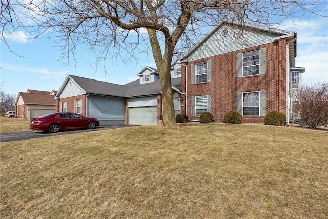 view of front facade with brick siding, an attached garage, driveway, and a front yard