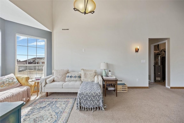 3260 Willowridge Rd Unit D, Marion, IA 52302 - carpeted living area with baseboards and a towering ceiling