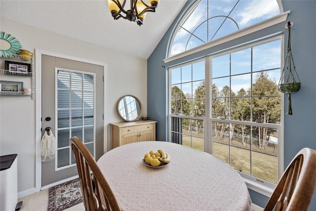 3260 Willowridge Rd Unit D, Marion, IA 52302 - tiled dining area featuring vaulted ceiling, baseboards, and a chandelier