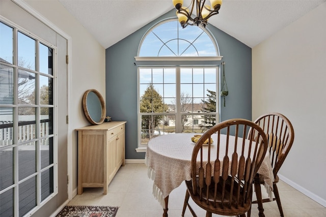 3260 Willowridge Rd Unit D, Marion, IA 52302 - dining room featuring a chandelier, vaulted ceiling, healthy amount of natural light, light tile patterned floors, and baseboards