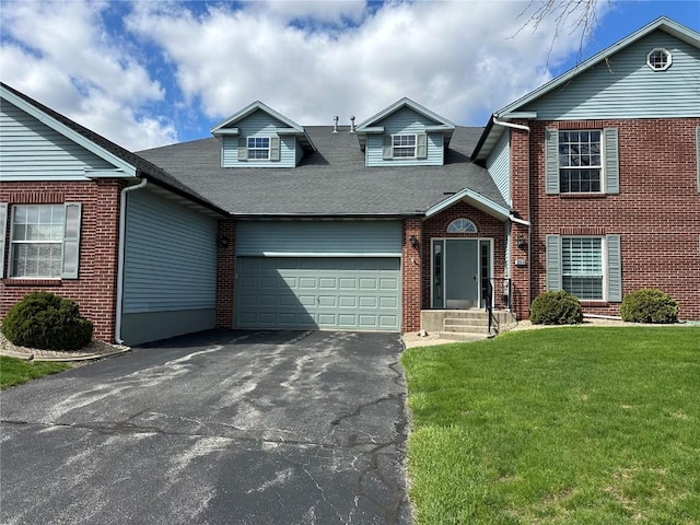 3260 Willowridge Rd Unit D, Marion, IA 52302 - view of front of house with an attached garage, a front yard, asphalt driveway, brick siding, and roof with shingles