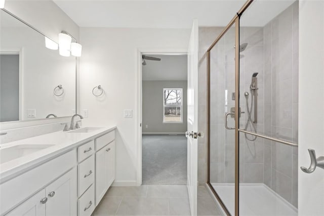bathroom featuring a shower stall, tile patterned flooring, and a sink